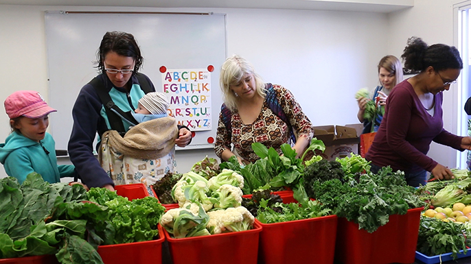 Rebecca Bork (middle) and her children, Ava and Finn, are among those who benefit from having fresh produce delivered by UCLA students. (Photo by Taya Kendall)